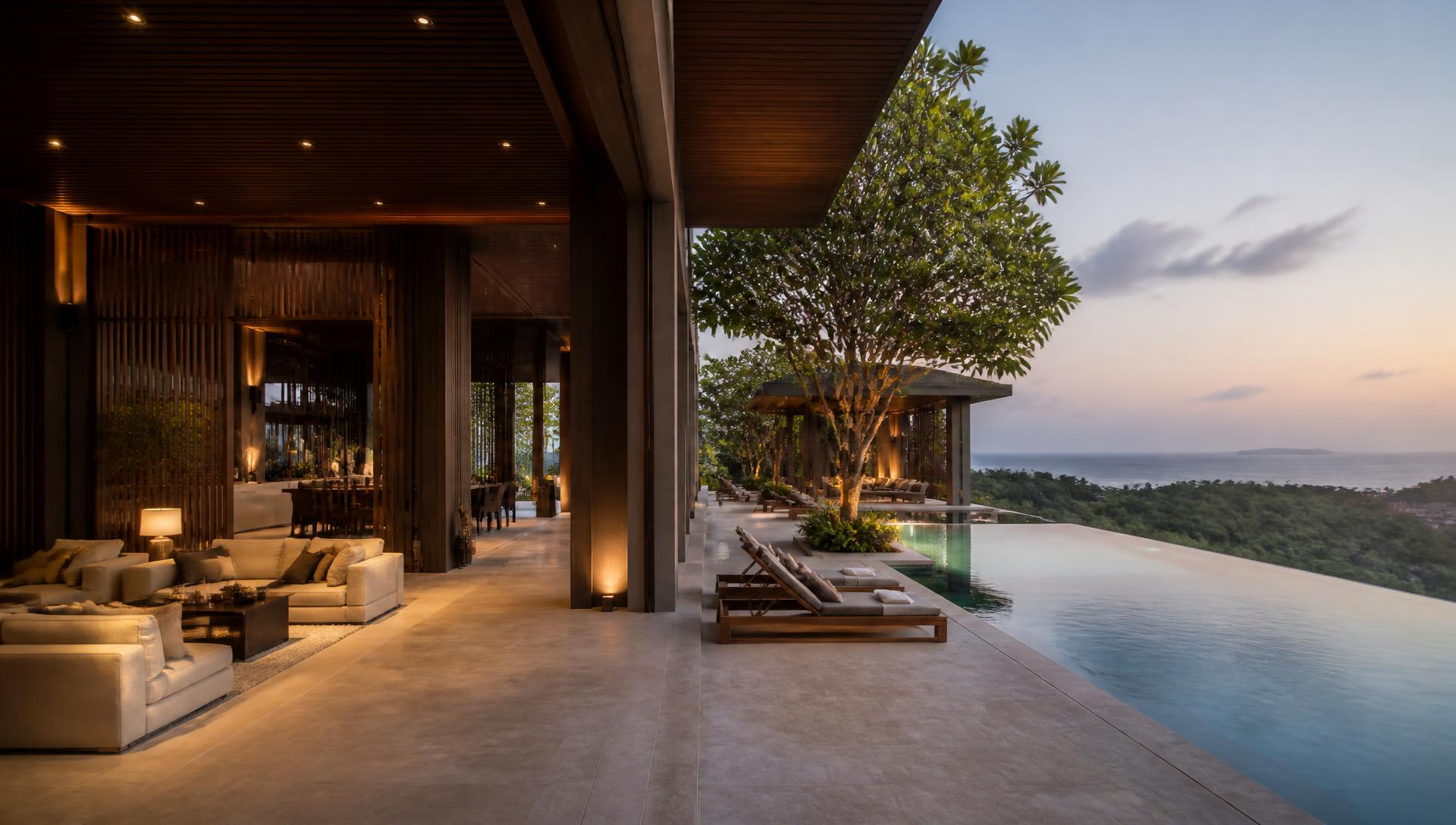 Branded residence terrace with an infinity pool, teak screens and a sea view at dusk